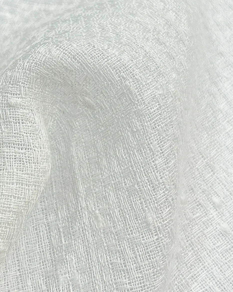 Close-up of sheer fabric sample with a textured weave, perfect for light, airy curtain designs or upholstery.