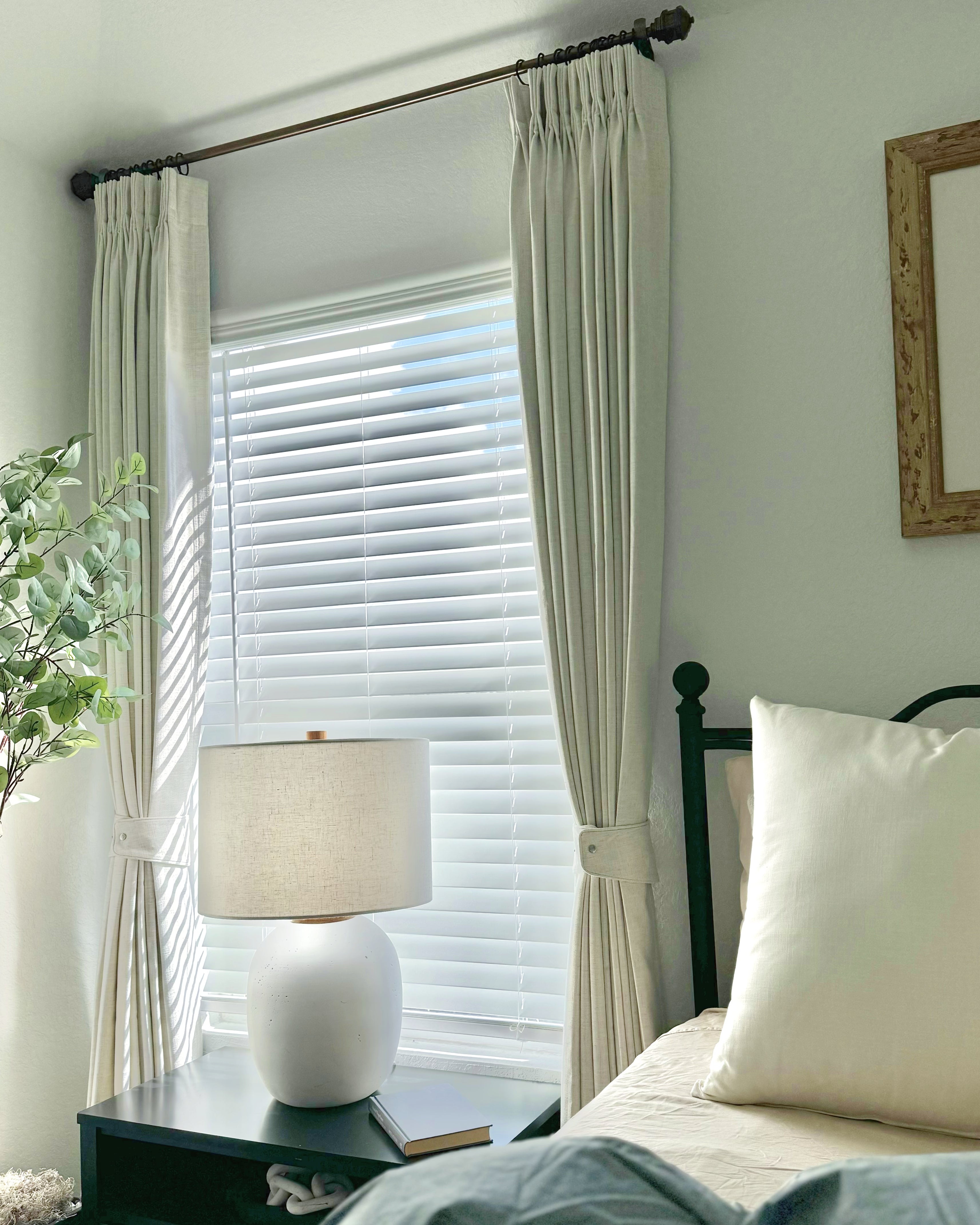 Luxury bedroom with stylish drapery, plush bedding, and elegant decor creating a comfortable and sophisticated atmosphere.