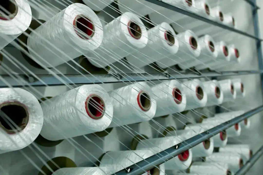 Spools of thread in a textile factory, illustrating the process of how to make curtains.